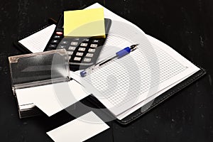 Office tools isolated on black wooden background, close up