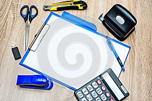 Office tools and paper sheet on wooden table