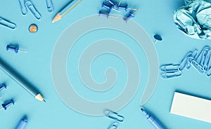 Blue office utensils on a blue background