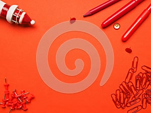 Red office utensils on red