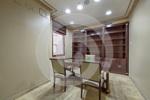 Office with vintage wooden table with matching bookshelf