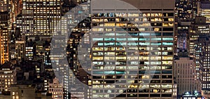 The office windows illuminated at night