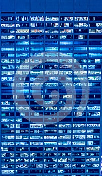 The office windows illuminated at night