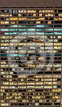 The office windows illuminated at night