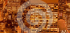 The office windows illuminated at night