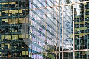 Office windows, reflections and shadows on glass exterior of business center building in Moscow city