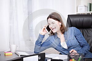 Office Woman Laughing While Talking on the Phone