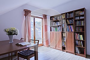 Office with wooden table and bookstand