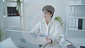 Office work concept. Happy mature middle aged woman talking to web cam video conference calling in virtual webcamera