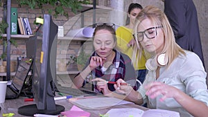 Office work, young creative female colleagues discussing business ideas