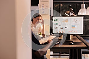 Office worker analyzing analytics report data on computer