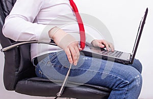 Office worker businessman with a laptop sitting on an office chair with a thick retractable stomach, bowel problems gas flatulence
