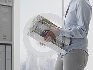 Office worker carrying paperwork in the office photo