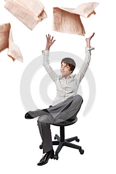 Office worker in a chair throwing newspaper up