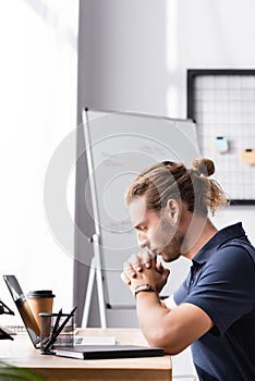 Office worker with clenched hands sitting