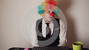 Office worker in clown wig, clown concept at work.