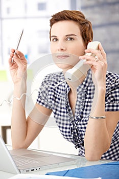 Office worker concentrating on phone call