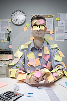 Office worker covered with stick notes