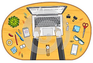 Office worker or entrepreneur working on a PC notebook, top view of workspace desk with human hands and diverse stationery objects