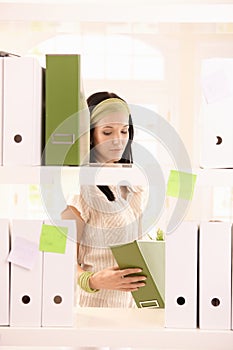 Office worker girl packing folders