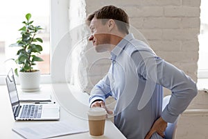 Office worker having strong lower back pain