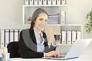 Office worker holding a coffee cup looking at camera