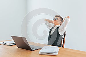 An office worker leans back in his chair, enjoying a moment of relaxation with his eyes closed