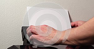 office worker loading paper into printer