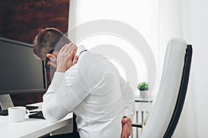 Office worker with pain from sitting at desk all day