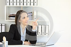 Office worker pointing at side to a blank space