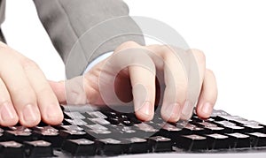 Office worker prints on the black keyboard