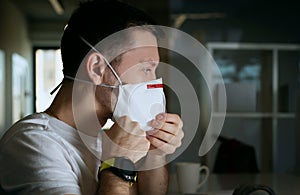 Office worker putting on a medical mask