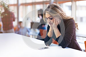 Office worker receiving bad news on the phone