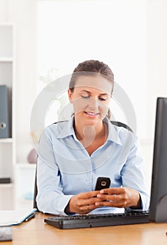 Office worker sending a text message