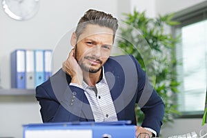 office worker with stiff neck photo