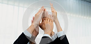 Office worker team stacking hand together symbolize successful teamwork. Shrewd