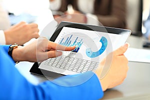 Office worker using a touchpad to analyze statistical data