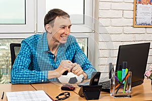 An office worker watches football and enjoys a goal scored