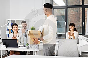 Office workers applauding to male colleague