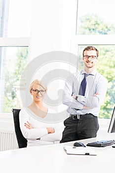 Office workers in formalwear working in office