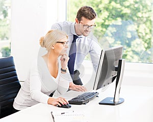 Office workers in formalwear working in office