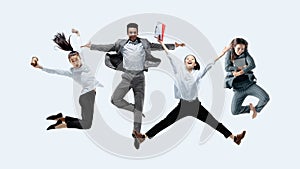 Office workers jumping isolated on studio background