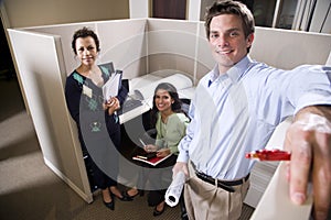 Office workers meeting in a cubicle