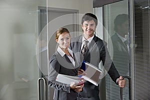 Office workers opening boardroom door