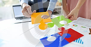 Office workers put together bright jigsaw elements