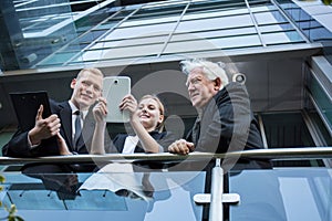 Office workers standing at the balcony