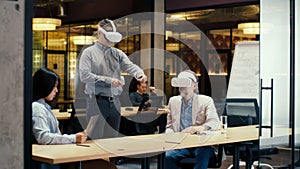 Office workers testing VR headset together