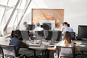 Office workers using computers working at modern big open space