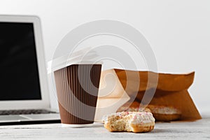 Office workplace with breakfast. Donuts and coffee