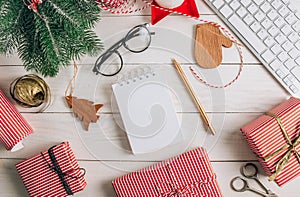 Office Workplace with Computer keyboard, empty notebook and Christmas Decoration